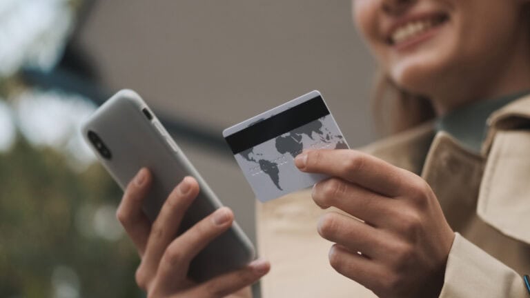 Close up woman paying for online purchases by credit card using