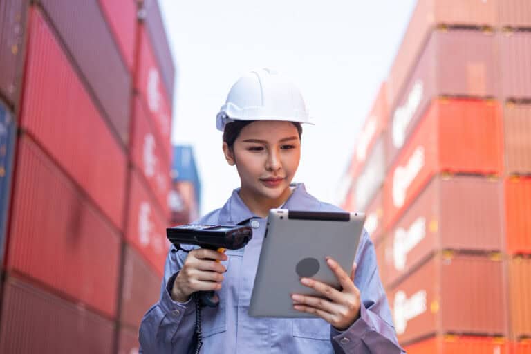 Portrait of an engineer inspecting products using a barcode scan